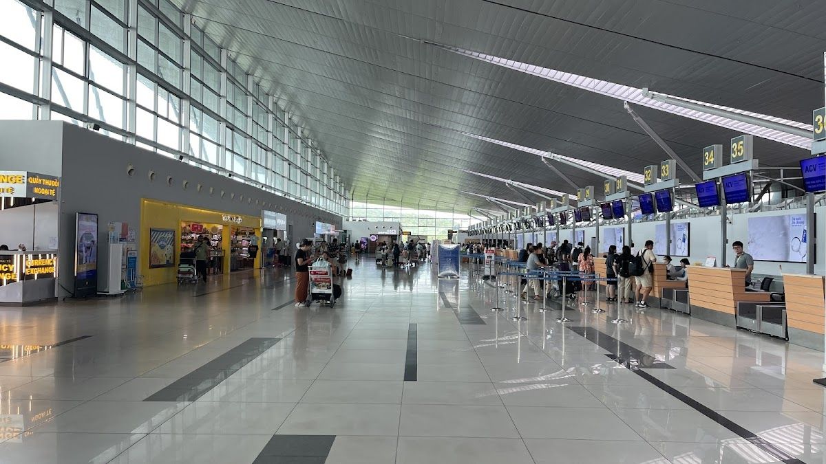 Phu Quoc International Airport check-in hall with check-in desks and travellers queuing