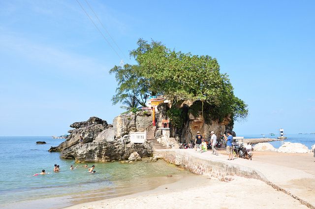 Dinh Cau Rock shrine jutting into the sea at the Duong Dong waterfront, next to the night market